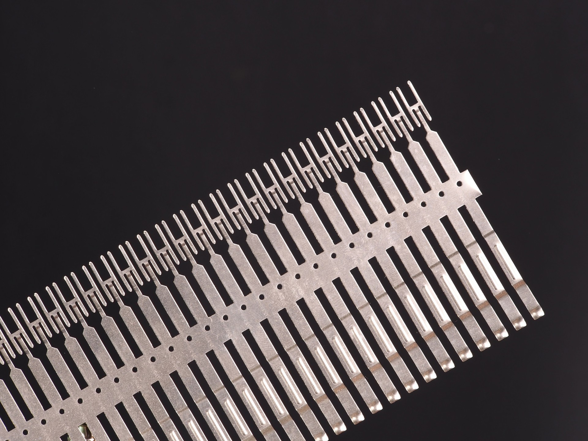 Stamped and plated row of precision springs