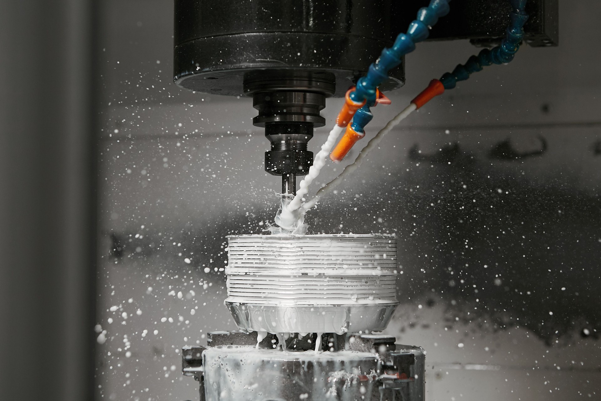 The CNC milling machine cutting the mold parts with oil coolant method. The mold and die manufacturing process by CNC machining center.