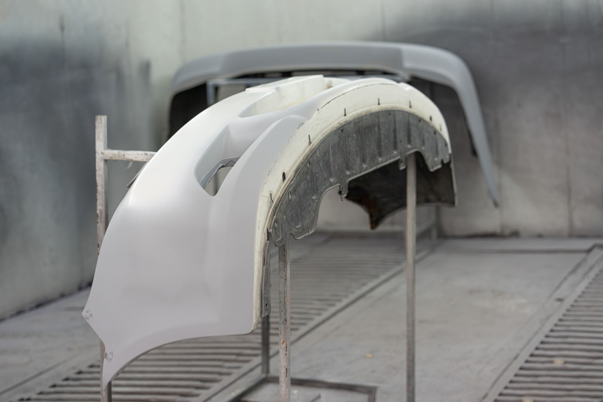 Part of car or front skirt painting in chamber at auto repair garage service. Car accessories decoration.